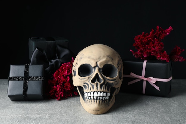 Skull flowers and gift boxes on black background