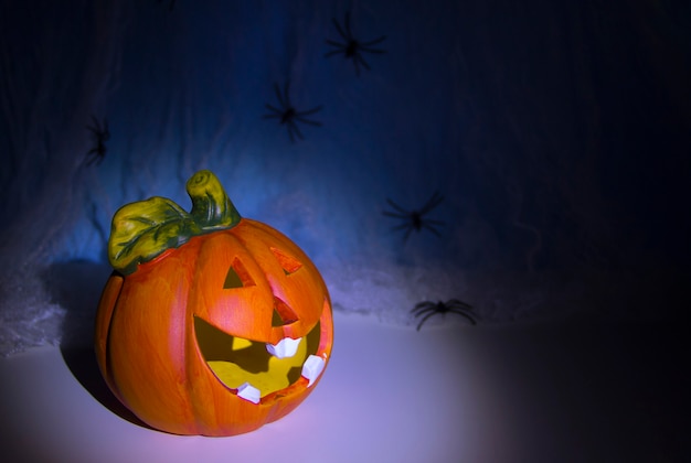 Skull Head and halloween pumpkin head of horrors rub is covered with cobweb