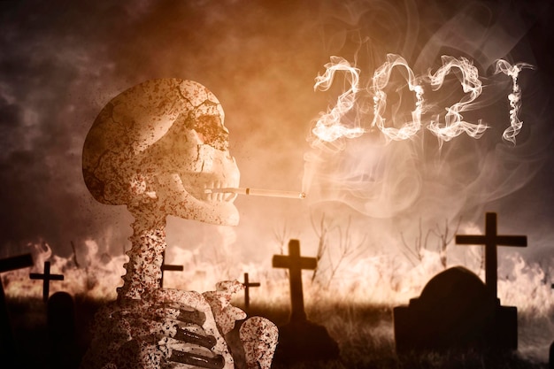 Skull human smoking with numbers 2021 in graveyard