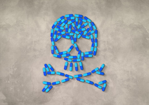 Skull made of blue capsule pills isolated on concrete background.