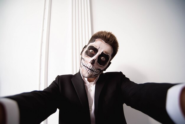 Skull make up portrait of young man, Halloween face art