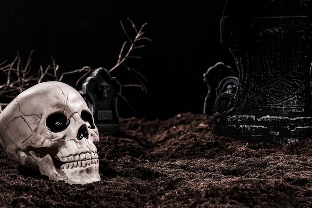 Skull on night cemetery with tombstones