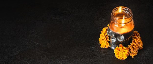 Skull with marigold flowers wreath on black banner Dia de los muertos day or day of the dead