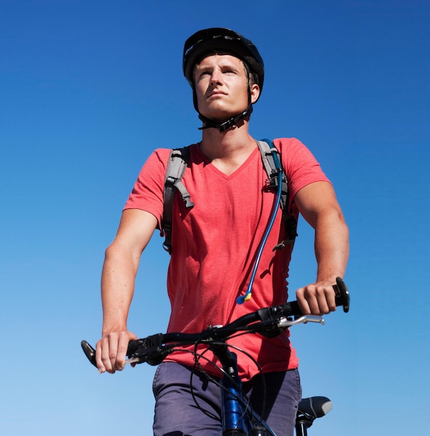 Sky bike and man focus on cycling journey sports workout or travel adventure for fitness exercise or outdoor cardio Thinking athlete training and male person riding bicycle for transportation