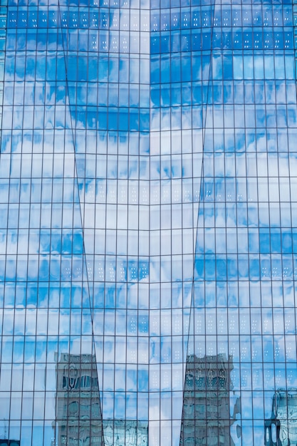 Sky and clouds reflected in a modern building glass facade