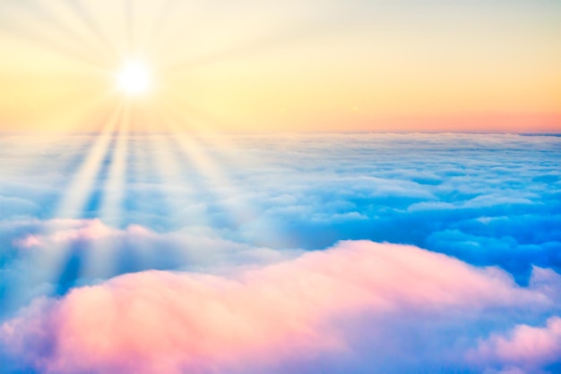 Sky and clouds at sunset landscape with sun rays aerial view from plane