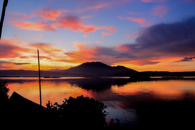 The sky is bright orange View of Sunset at Rawa Pening