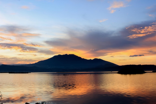 The sky is bright orange View of Sunset at Rawa Pening