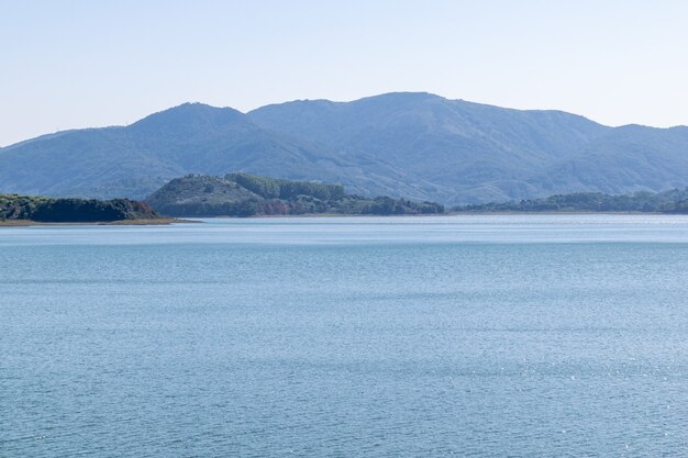 The sky and the lake are blue, and the mountain is opposite the lake