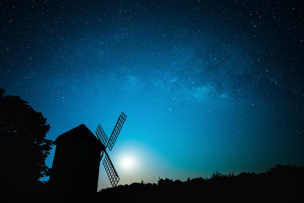 Sky at night with moon and wind turbine