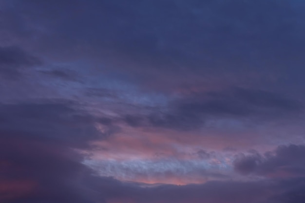 Photo sky with clouds at sunset and sweet hour with pastel shades of the blue and red range