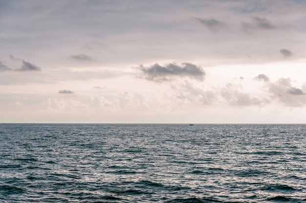 The sky with clouds, waves on sea surface