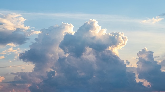 Sky with picturesque fluffy clouds at sunset