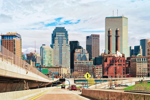 Skyline of skyscrapers and Boston road with car traffic, MA, USA.