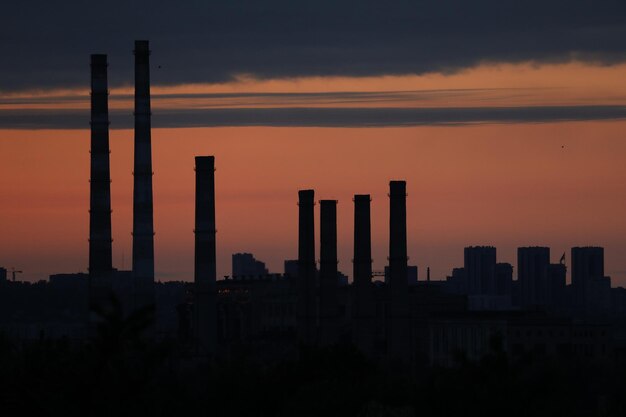 skyline with burning sky in industrial city with plant