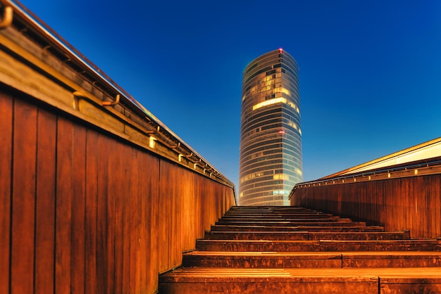 Skyscraper in Bilbao Spain framed in the stairs of the Ria de Bilbao bridge