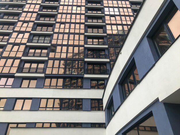 Skyscraper residential high building with frosted windows in the city center bluewhite glass walls