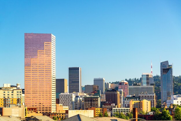 Skyscrapers in city against blue sky