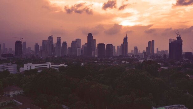 Photo skyscrapers during sunset in jakarta