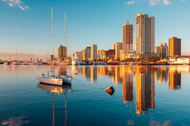 Skyscrapers and their reflection on the lake in  Manila Bay Manila Philippines