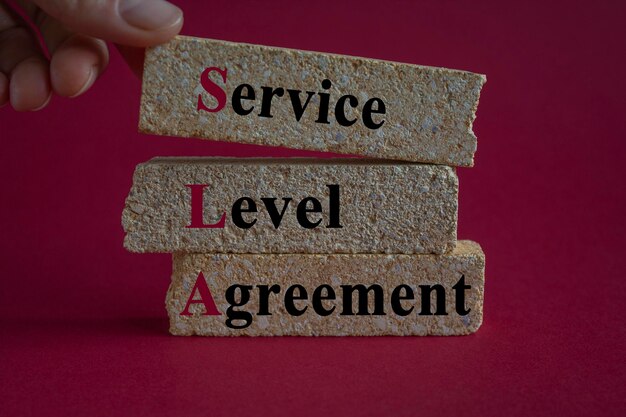 Photo sla service level agreement symbol concept words sla service level agreement on brick blocks