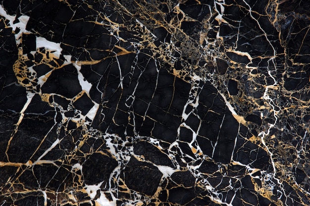 A slab of black marble with beautiful yellow and white veins called New Portoro.