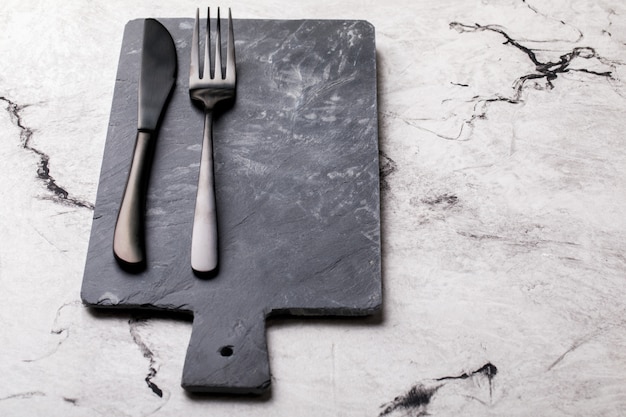 Slate board Black for feeding a fork and a knife.