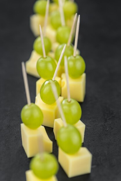 Slate slab with Cheese blocks and grapes partyfood