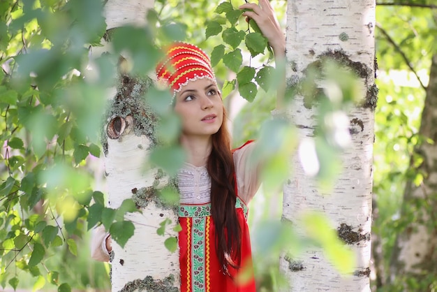 Slav in traditional dress hiding behind trees