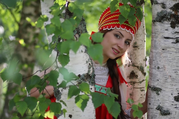 Slav in traditional dress hiding behind trees