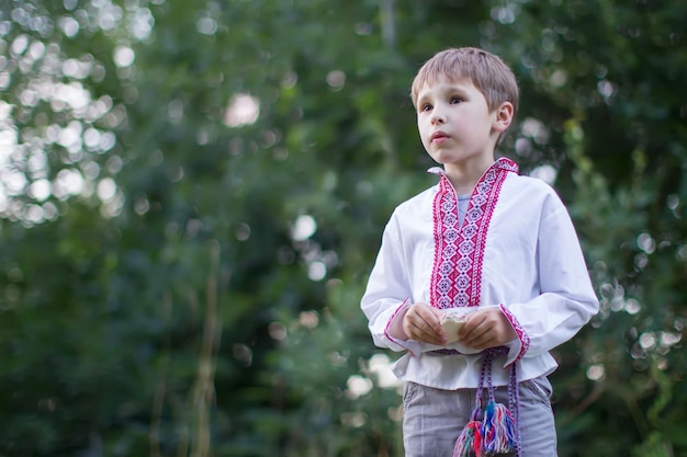 Slavic child in national clothes Ukrainian boy Byelorussian