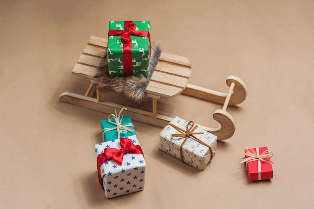 Sled with gifts on craft paper background