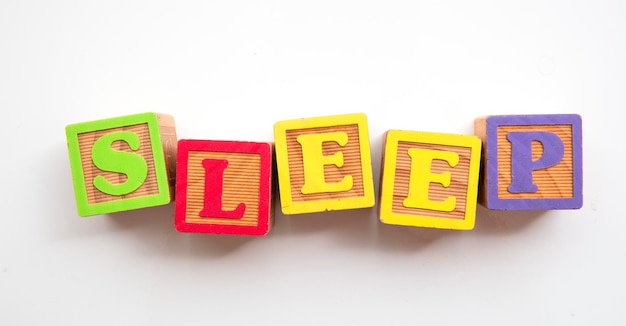 Sleep word made from colourful wooden baby development blocks