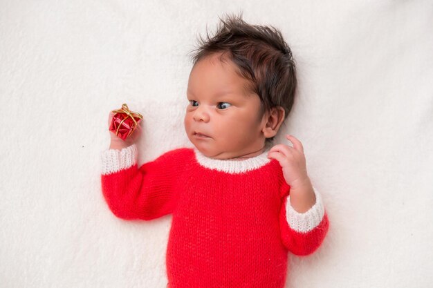 Sleeper newborn baby in a Christmas Santa cap