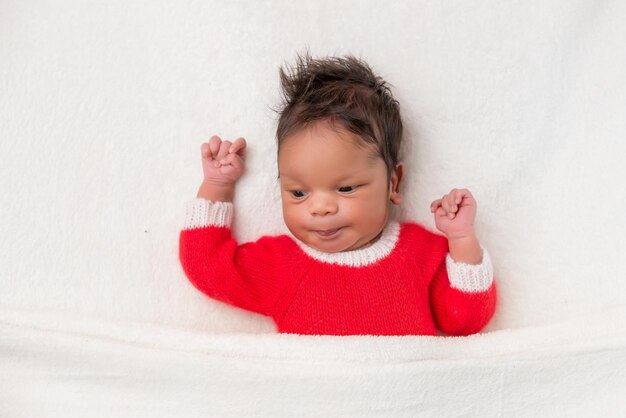 Sleeper newborn baby in a Christmas Santa cap