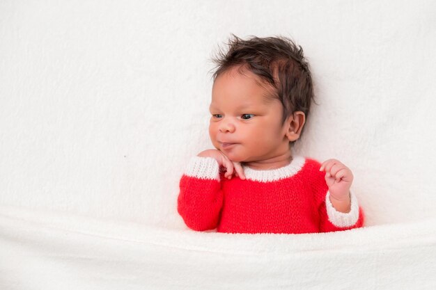 Sleeper newborn baby in a Christmas Santa cap