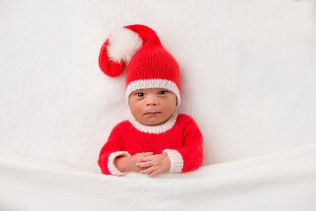 Sleeper newborn baby in a Christmas Santa cap