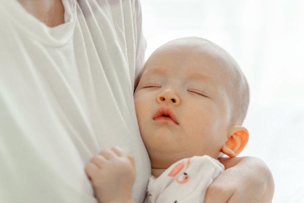 The sleeping baby on Embrace mother