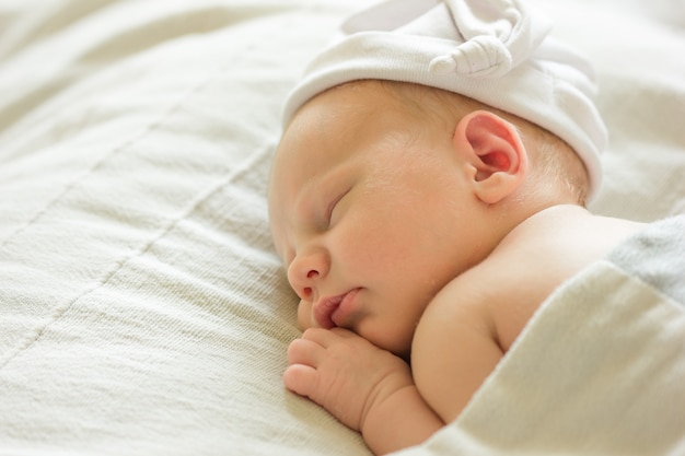 Sleeping Baby, New Born Kid Sleep in Hat, Beautiful Newborn Infant in Bed, two weeks old