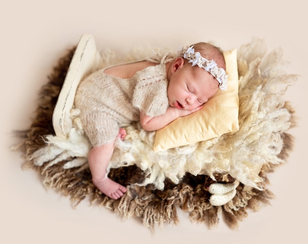 Sleeping baby on wool