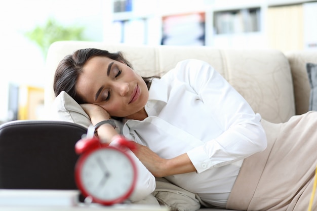 Sleeping businesswoman on sofa