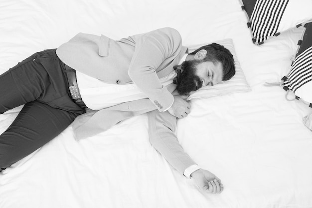 Sleeping in fashionable clothes recovery and recharging feel\
tired and sleepy sleepy guy in formal clothes sleep bed top view\
lack of sleep need more sleep evening time businessman\
exhausted