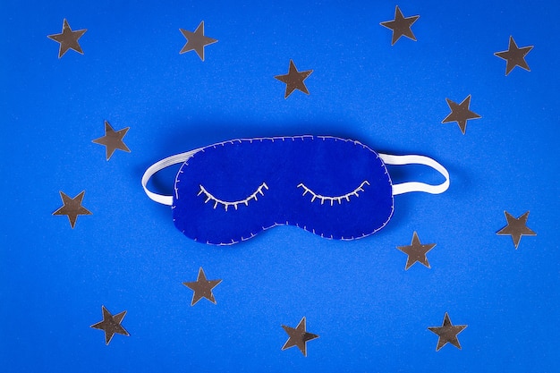 Sleeping mask handmade made of felt, stars on a blue background.