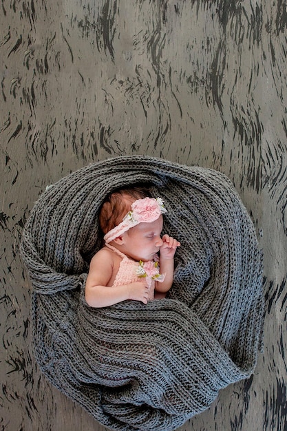 Sleeping newborn girl on a pink backgroundPhotoshoot for the newborn 20 days from birth A portrait of a beautiful seven day old newborn baby girl