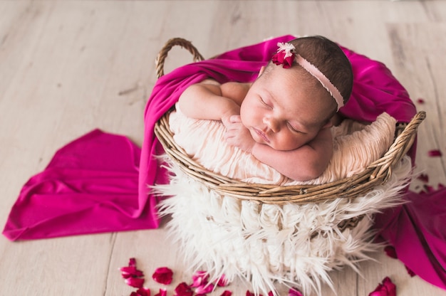 Photo sleeping tender baby under pink blanket