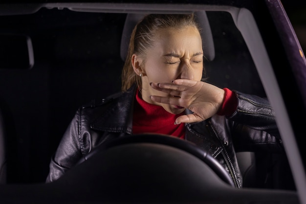 Sleeping woman sits inside car