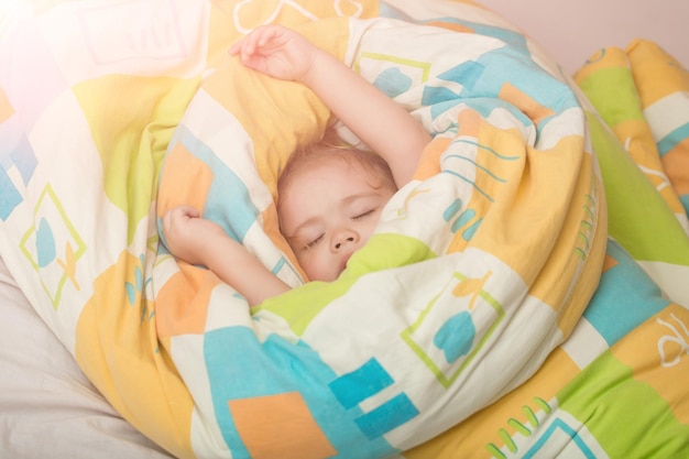 다채로운 담요에 졸린 아기입니다.