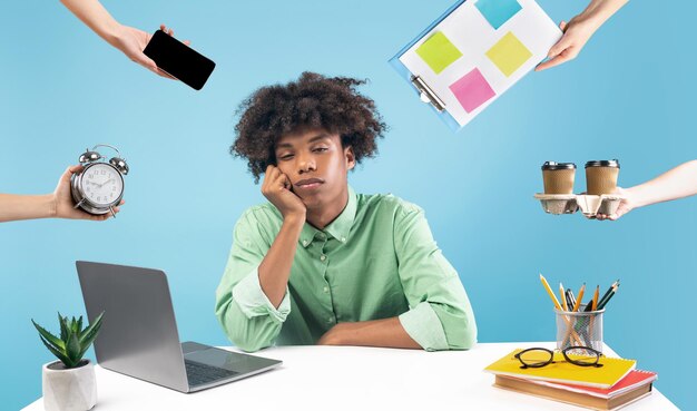 Photo sleepy black guy surrounded by hands with different stuff