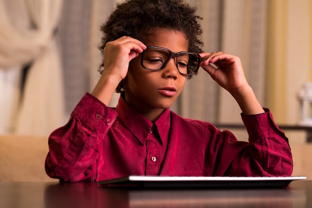 Sleepy black kid at keyboard.