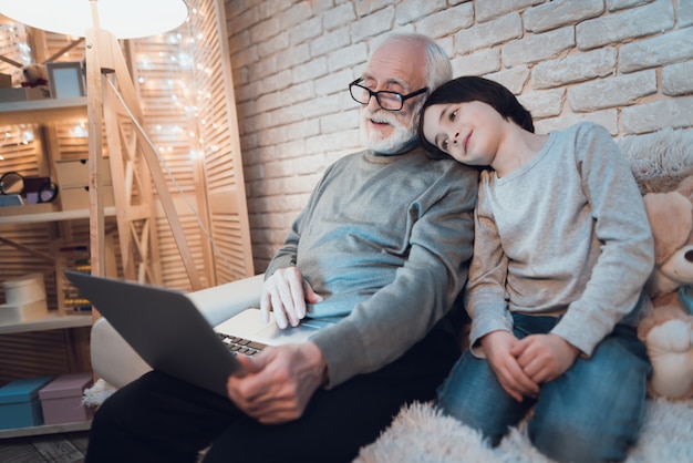 Sleepy Boy Sitting Near Working Laptop Grandpa